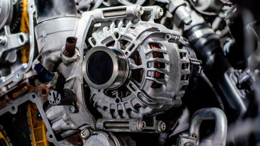 close up of a mounted car alternator with visible copper coils